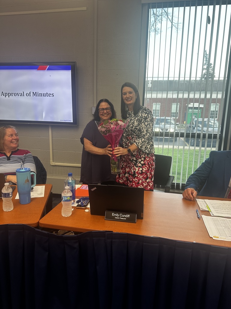 board of education president debbie callihan thanks interim treasurer emily cundiff with some flowers to thank her for her service to the district photo