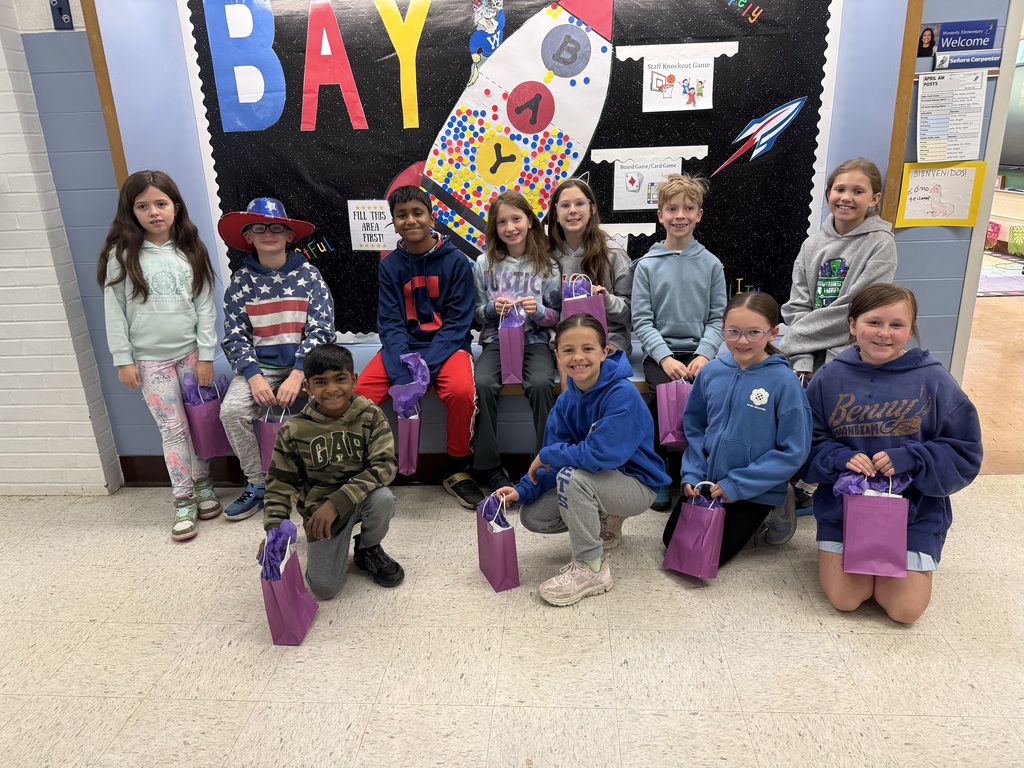 This photo features military-connected students in grades 3 & 4 with purple goody bags during Month of the Military Child in April 2026.