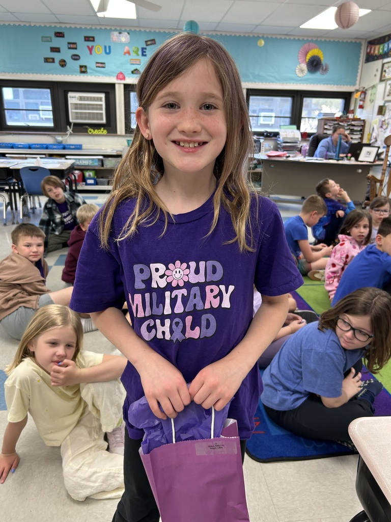 Military Connected student holding a purple goody bag in April 2026.