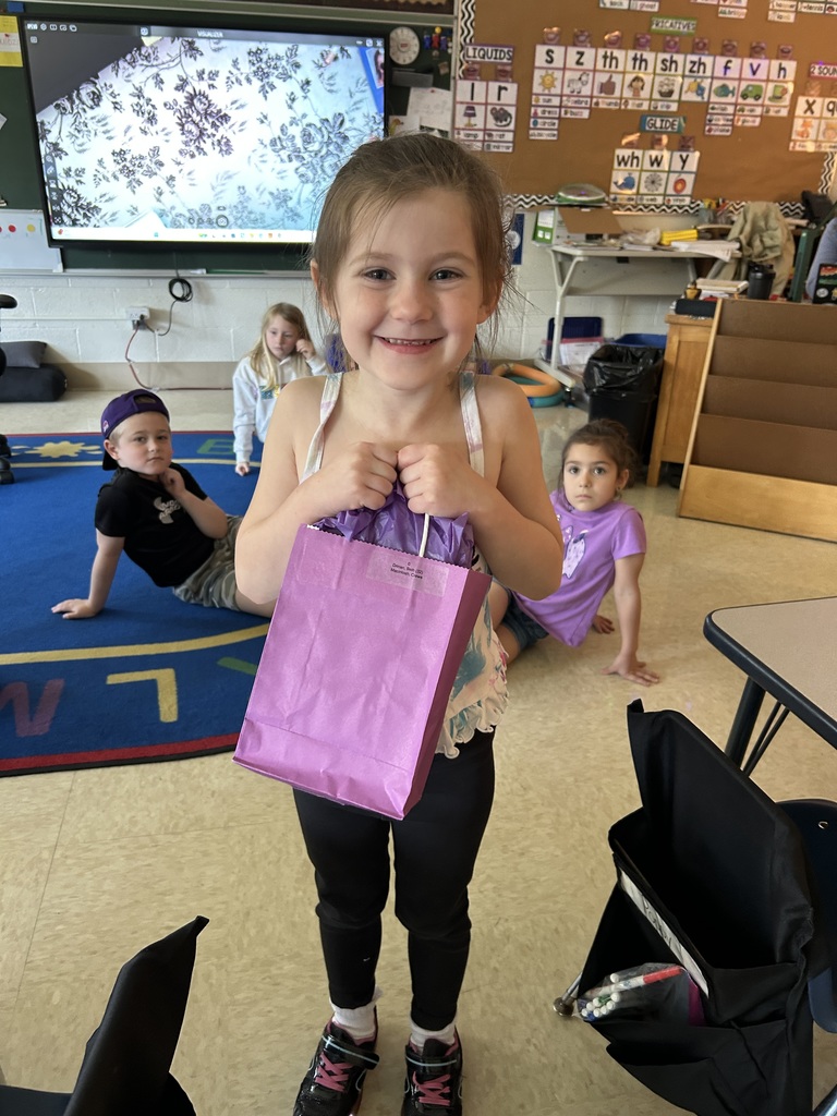 Military Connected student holding a purple goody bag in April 2026.