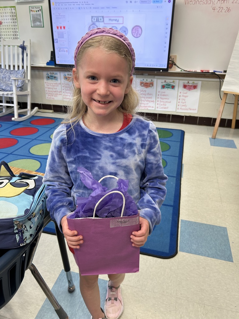 Military-connected student shown with a purple goody bag in April 2026.