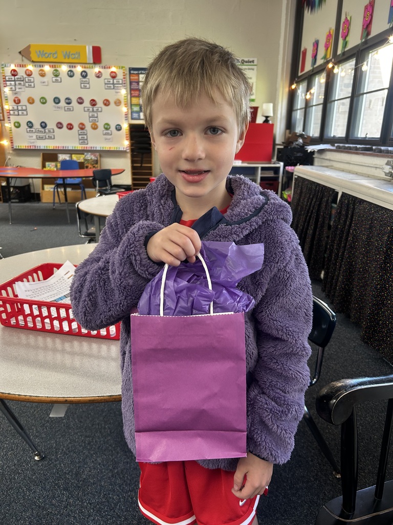 Normandy Military-Connected student holding a purple goody bag in April of 2026.