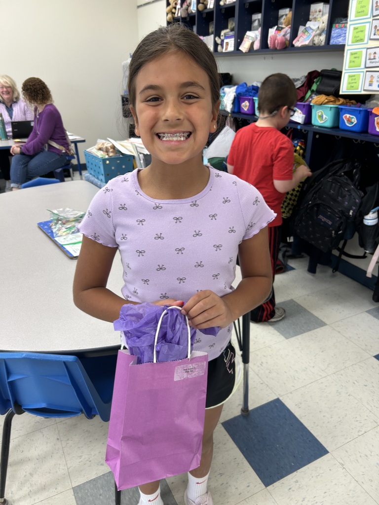 Military-connected student shown with a purple goody bag in April 2026.