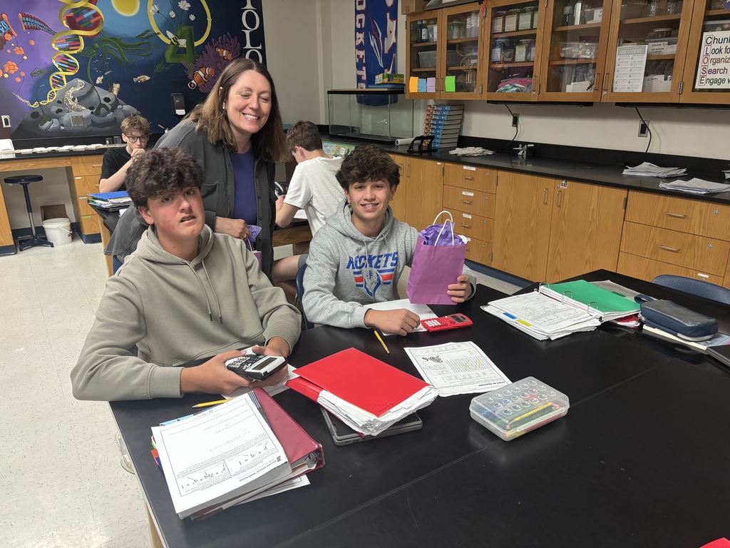 Bay High School military-connected students with their teacher and a purple goody bag.