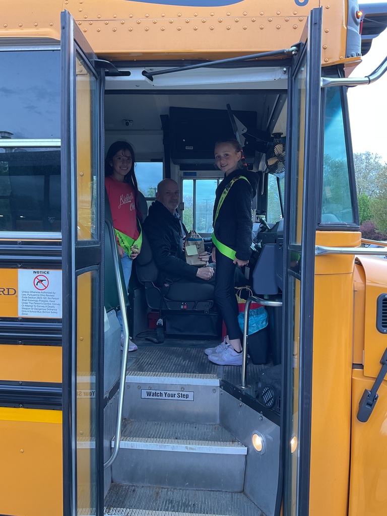 School Bus Driver Appreciation Day 2026 with a student presenting a goody bag to a bus driver.