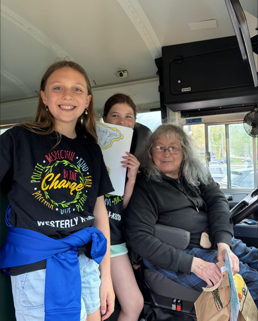 School Bus Driver Appreciation Day 2026 with students presenting a goody bag to a bus driver.