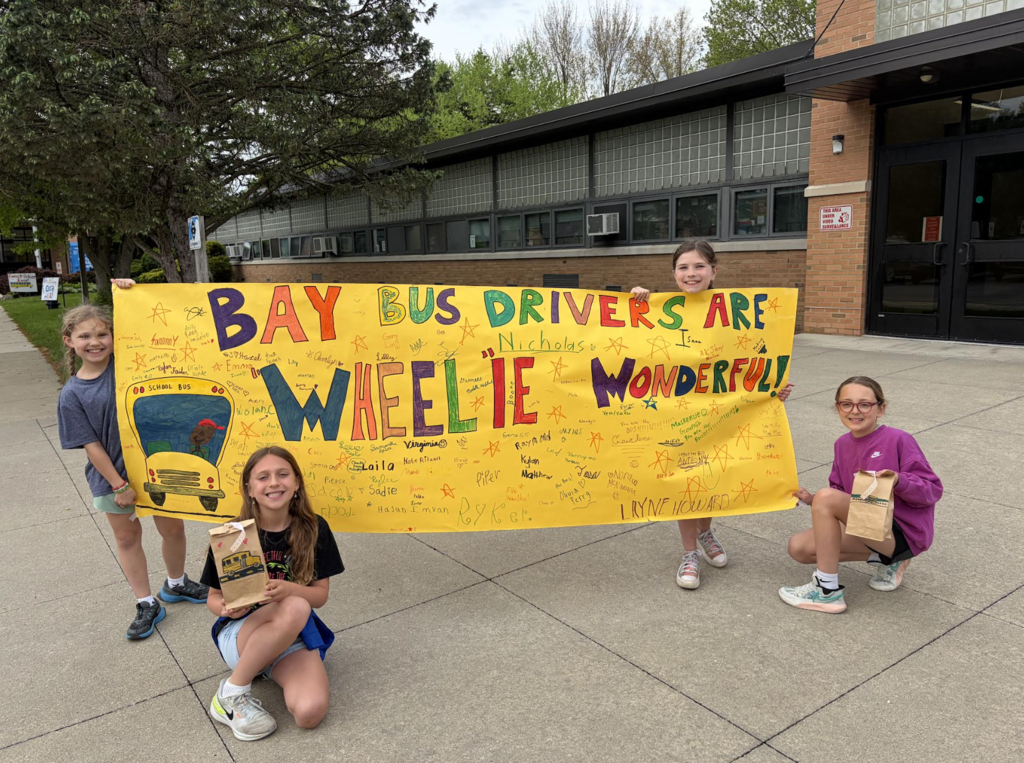 School Bus Driver Appreciation Day 2026 with students holding a handmade poster.