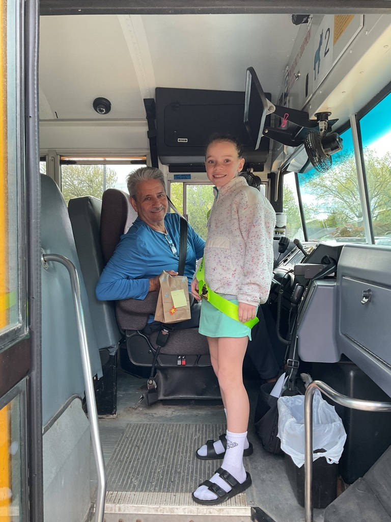School Bus Driver Appreciation Day 2026 with a student presenting a goody bag to a bus driver.