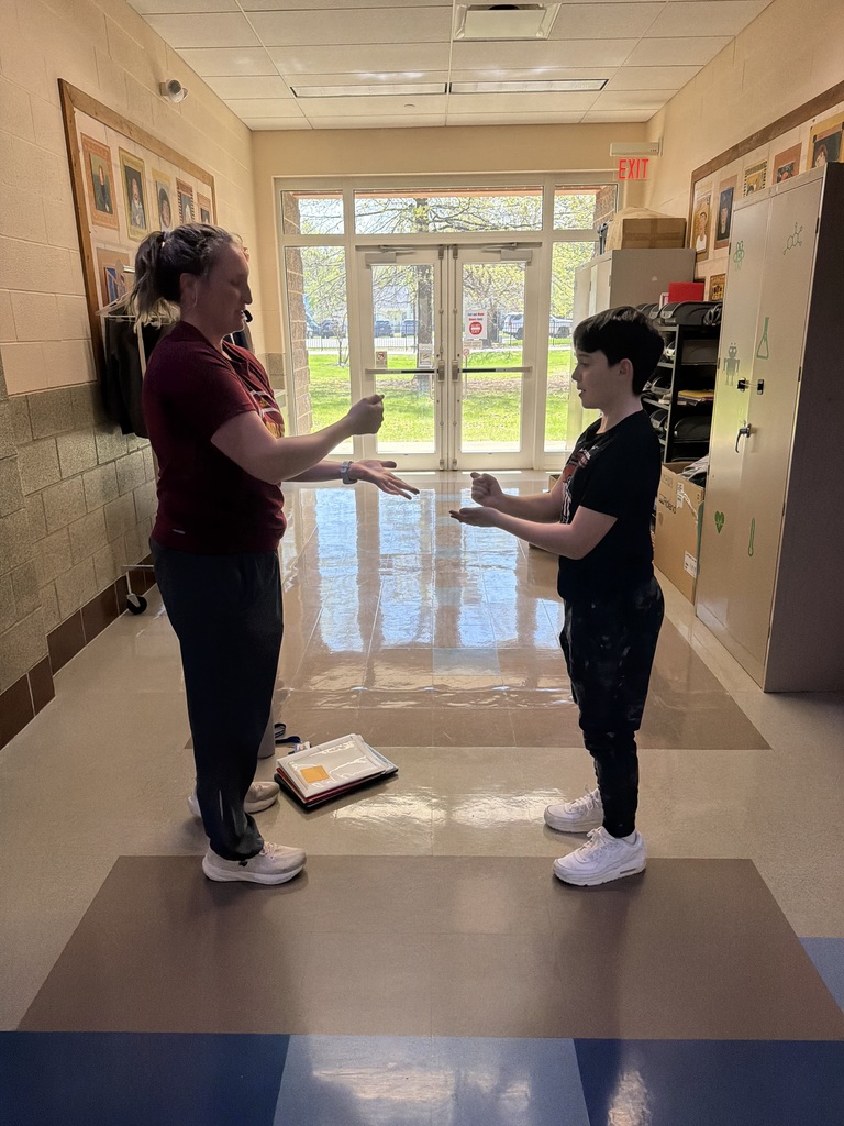 Rock paper scissors photo at bay middle school with teacher and student.