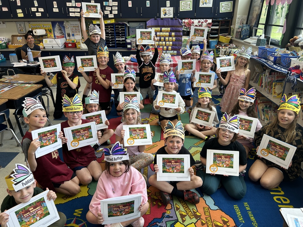 Mrs. Hart's second-graders are published authors, photographed with their books.