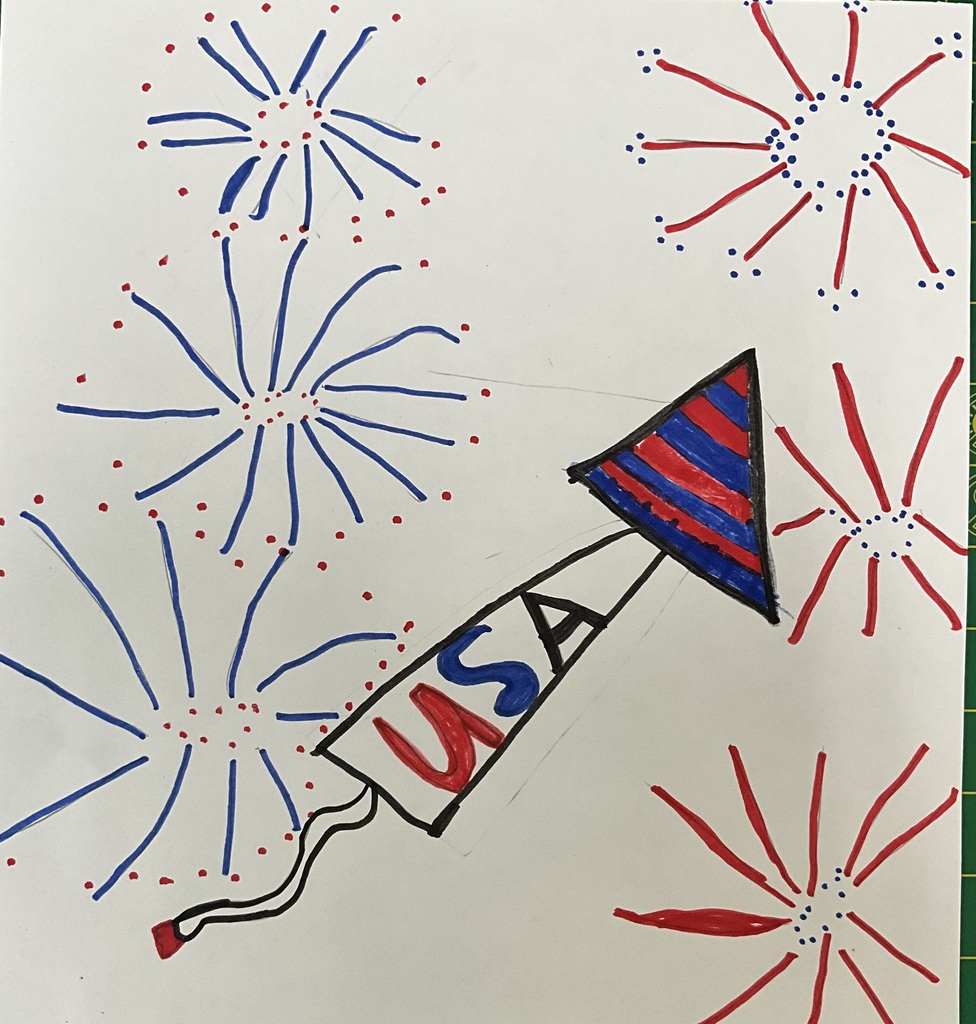 First-grade artwork showing fireworks and a USA rocket.