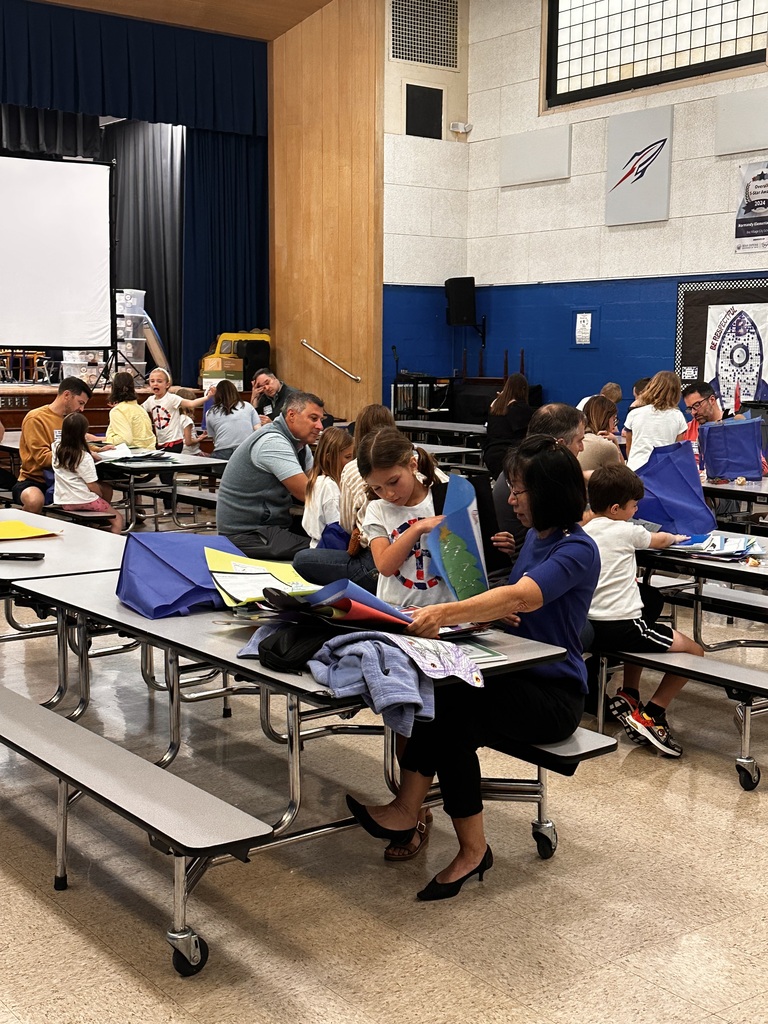 Portfolio Day at Normandy School with students and their families going over their body of work.