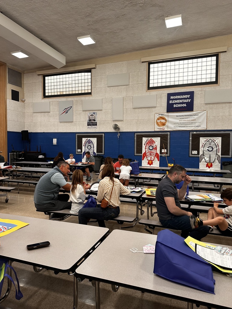 Portfolio Day at Normandy School with students and their families going over their body of work.
