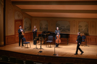 Photo of BMS eighth-grader Anton Bekeny has members of the cleveland orchestra finish playing his composition.