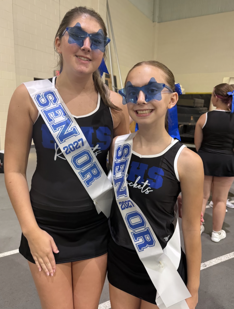 Two Bay High School Cheerleaders are pictured wearing star sunglasses and Senior banners.