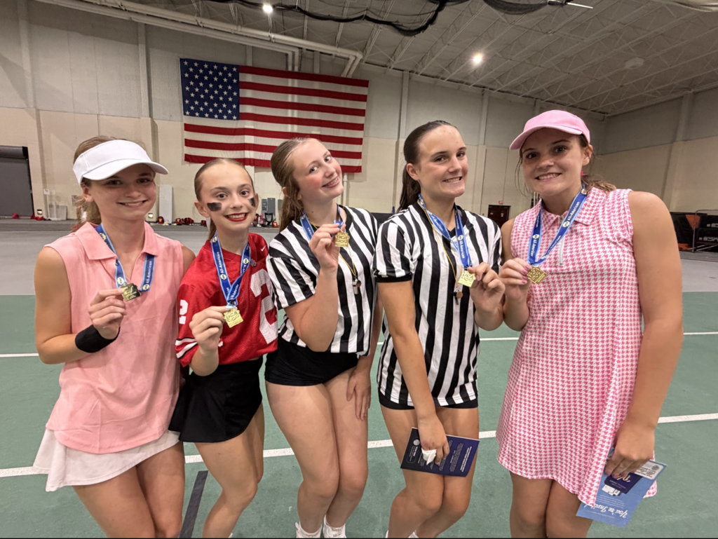 Five Bay High School cheerleaders are pictured showing off their All American medals. 