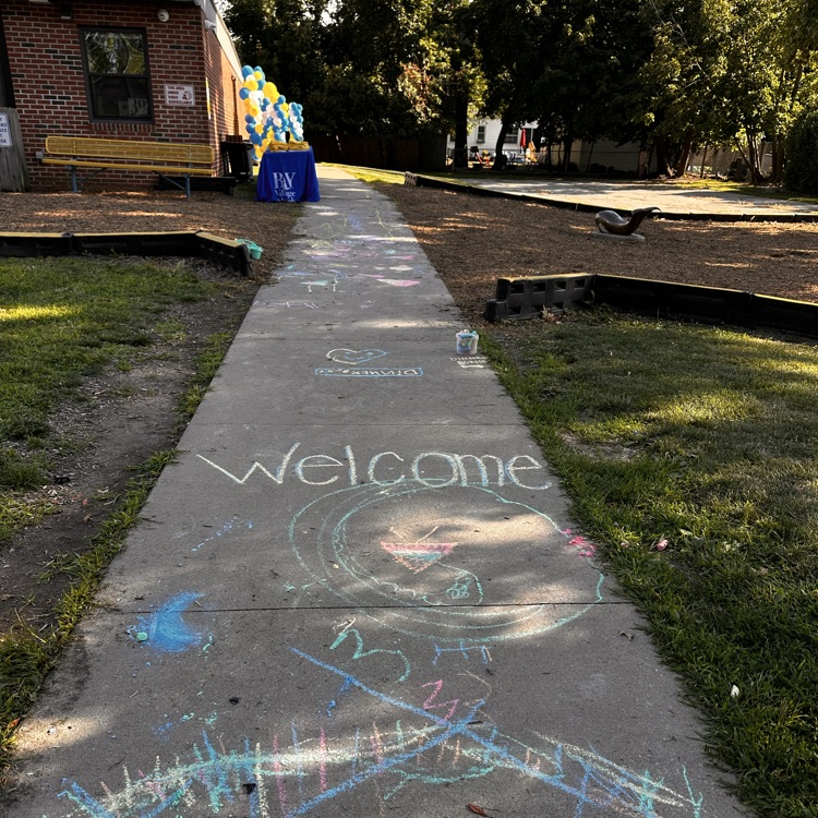 hey, welcome sign done in chalk on a sidewalk