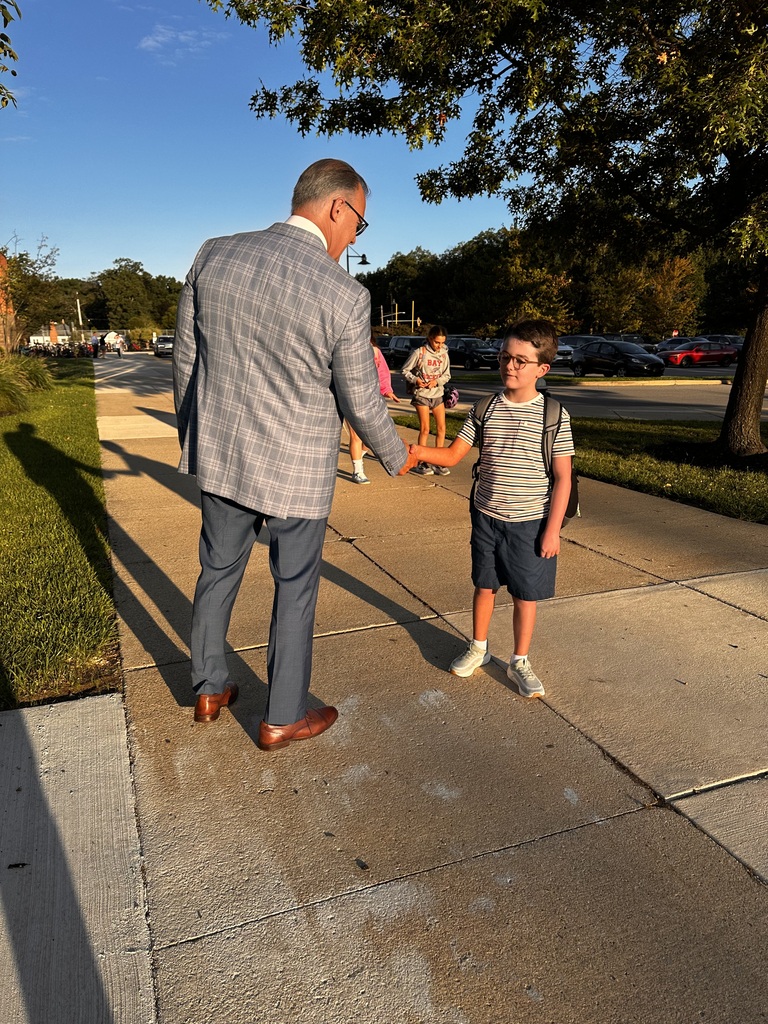 A Bay Middle School student shakes hands with the supt on the first day of school. 