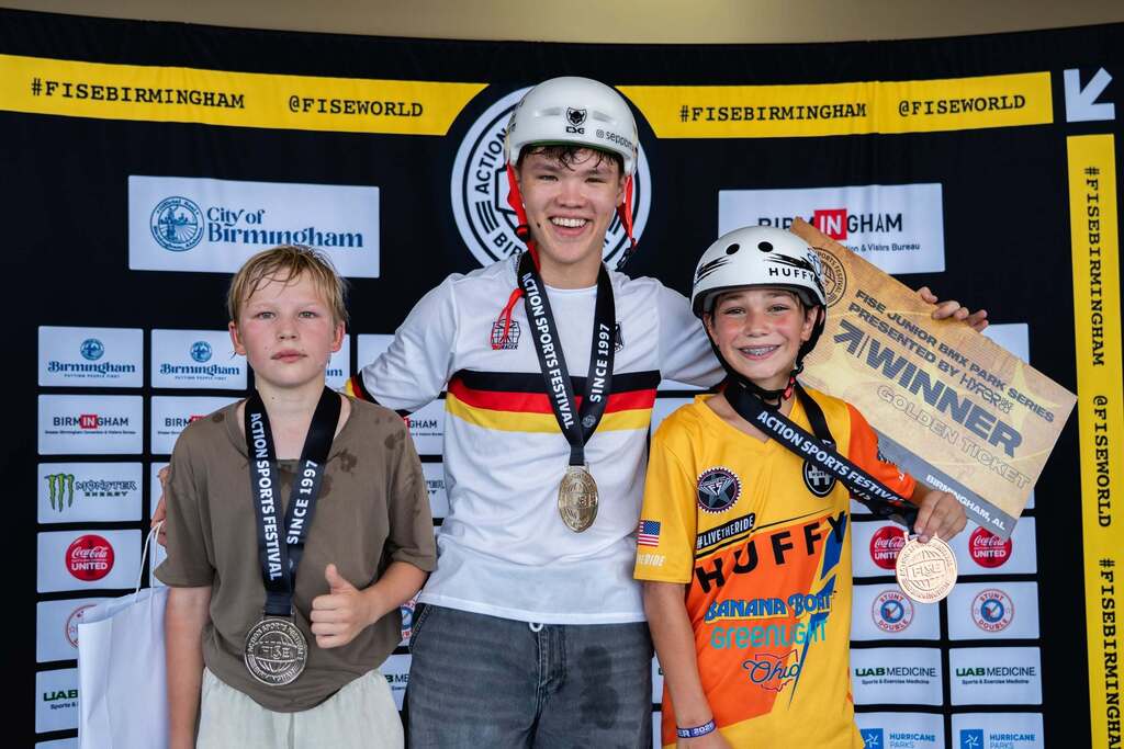 BMX junior champions on the podium with their medals.