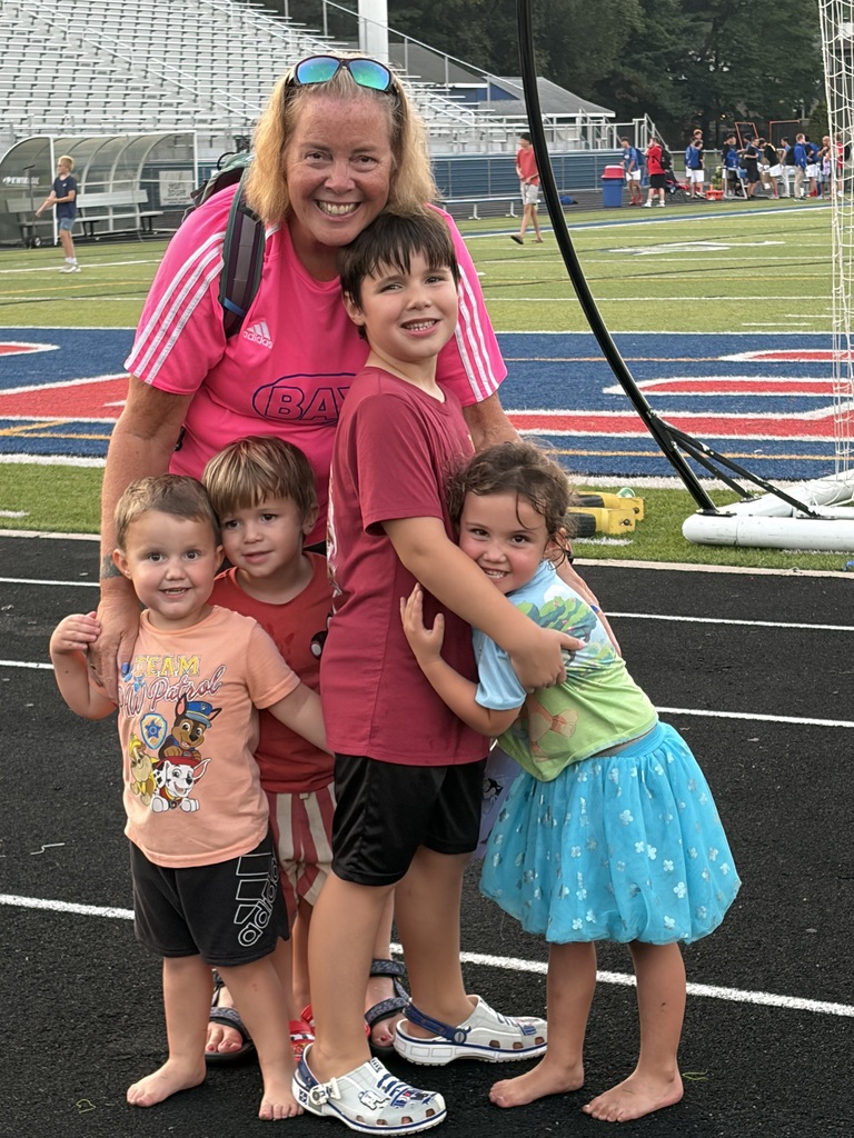 Grandparents day photo of a grandma with four grandkids on the Bay High School track.