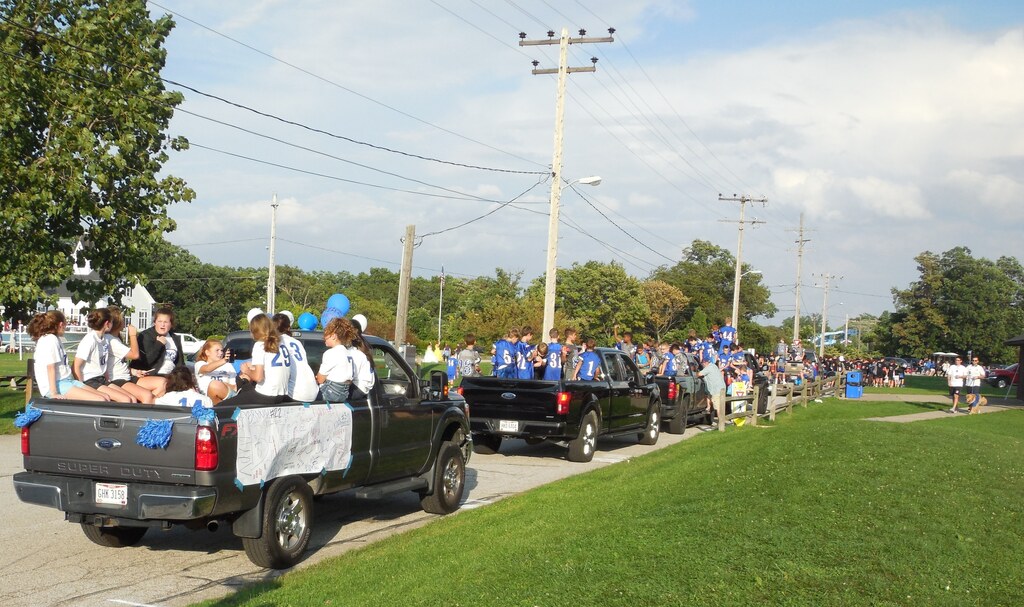 football team in the back of a pickup truck during a past homecoming parade