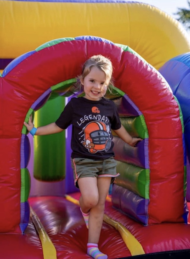 A photo of a little girl coming out of a jumpy trampoline set up.