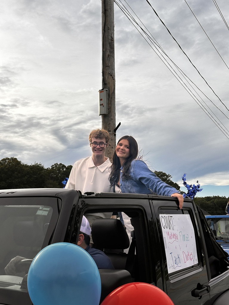 Homecoming court students in a jeep lined up for the parade.