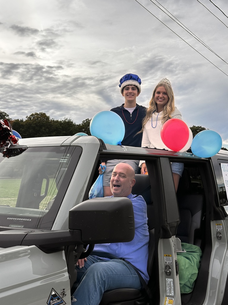 The homecoming king and queen inside a jeep waiting for the parade to kick off.