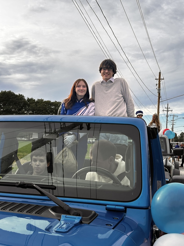 Homecoming court students in a jeep waiting for the parade to step off.