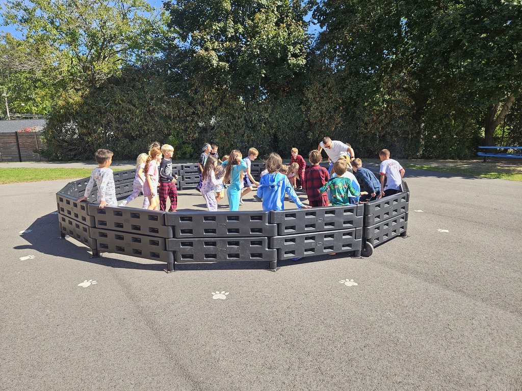 Elementary students playing Gaga Ball on the playground.