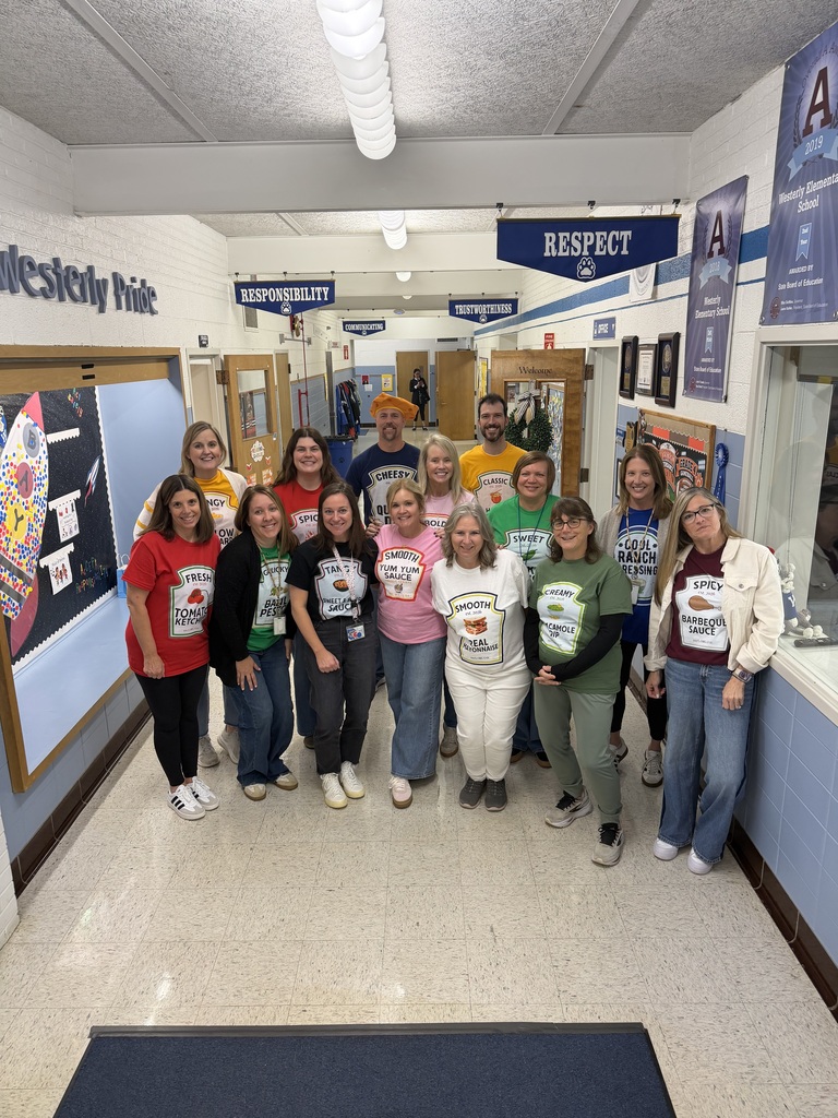 Fourth-grade educators standing in the school hall with their Halloween costumes on, which are all condiment varieties.