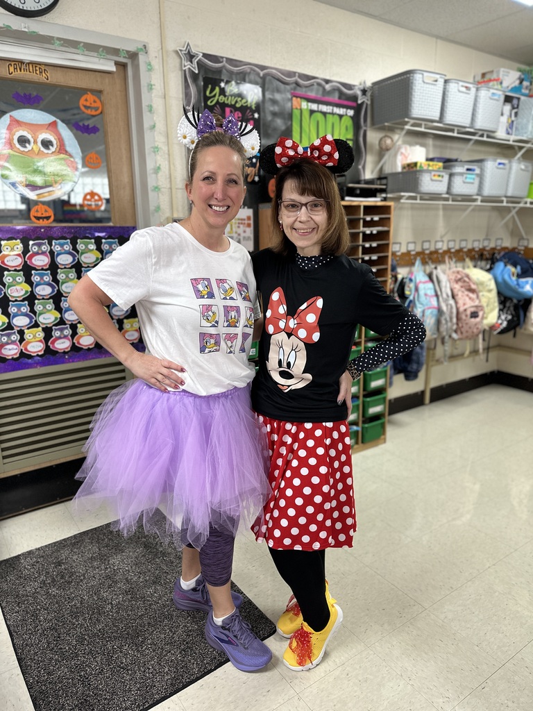 Third-grade teachers dressed as Daisy and Minnie.