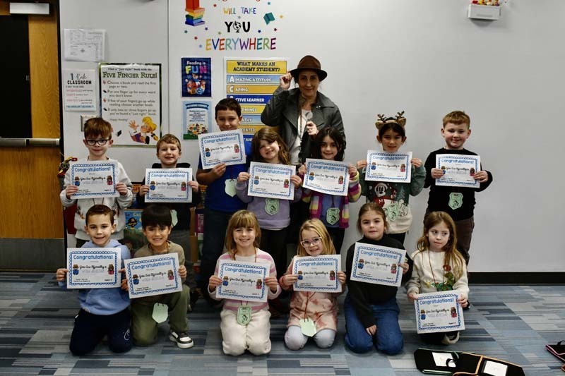 Students sitting with teacher.