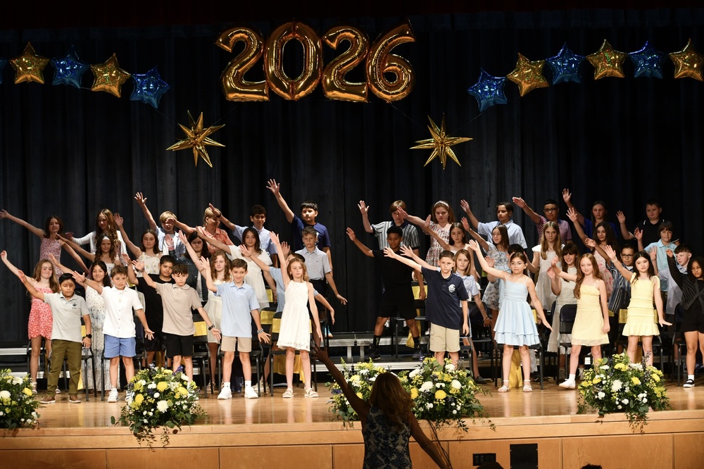 Students raising their arms in the air.