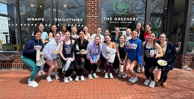 Students standing in front of The Greenery storefront.