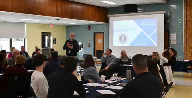 Man giving presentation to students.