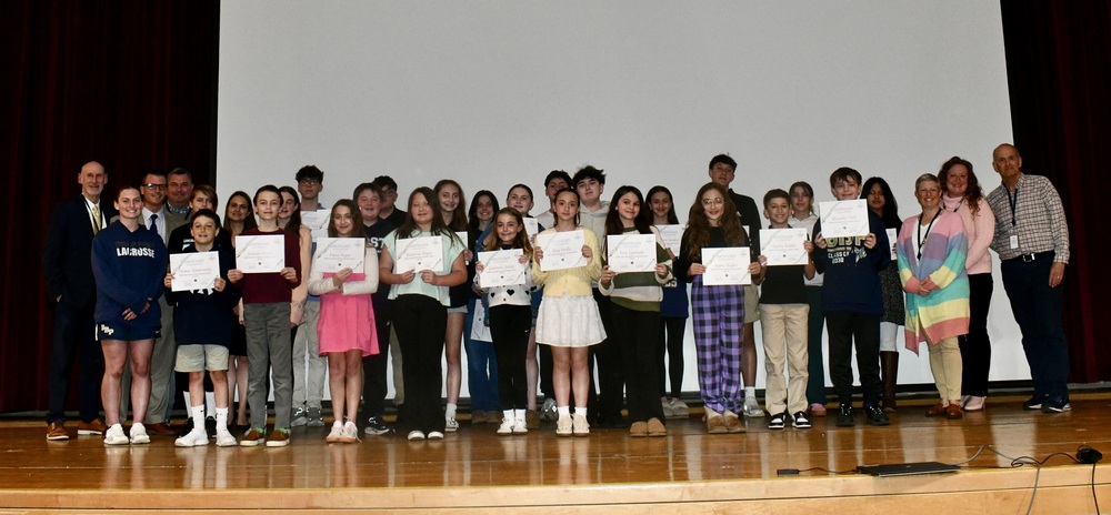 Students holding certificates.