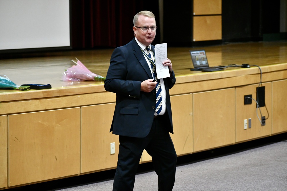 Superintendent giving speech in auditorium.