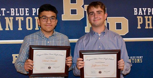 Two high schoolers receiving awards.