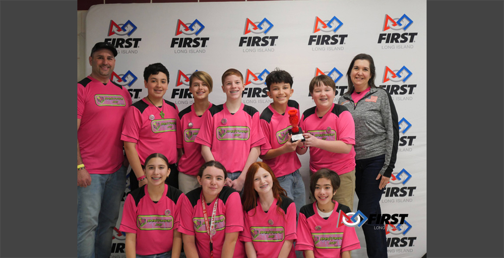 people stand in a line on a stage with red curtains. They appear confident and composed, suggesting a formal or celebratory event.