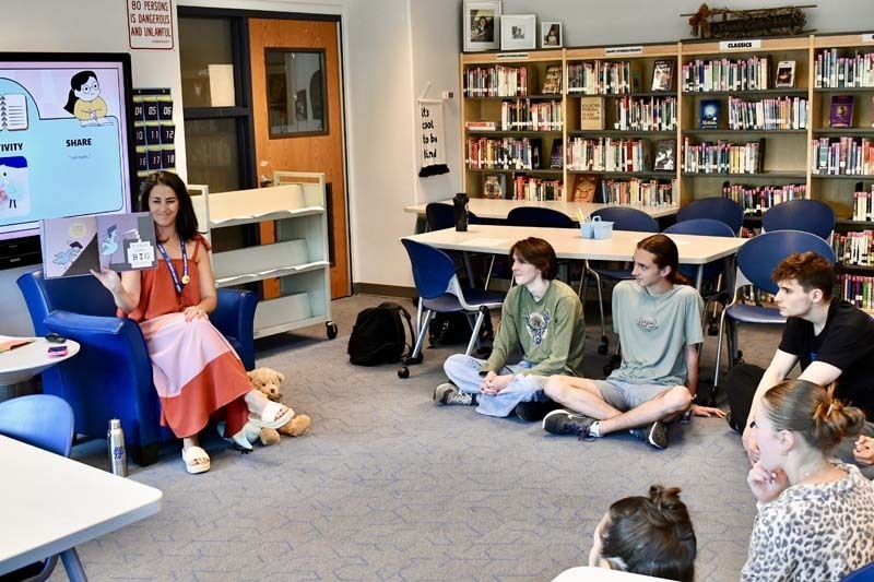 Seniors in Mrs. Pintar’s AP Literature class took a trip down memory lane during one of their final days together, gathering in the library for a special read-aloud reminiscent of their elementary school years.