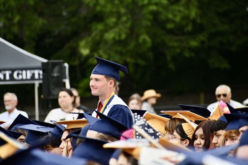 Graduating students smiling.