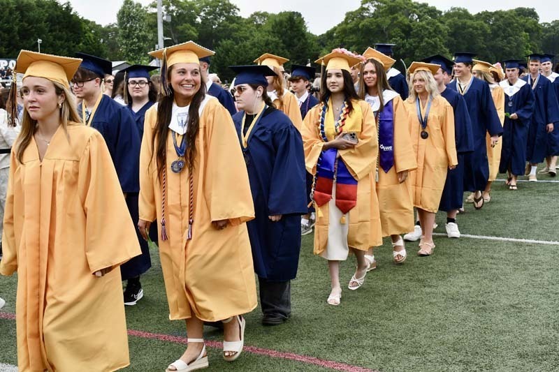 Graduating students smiling.