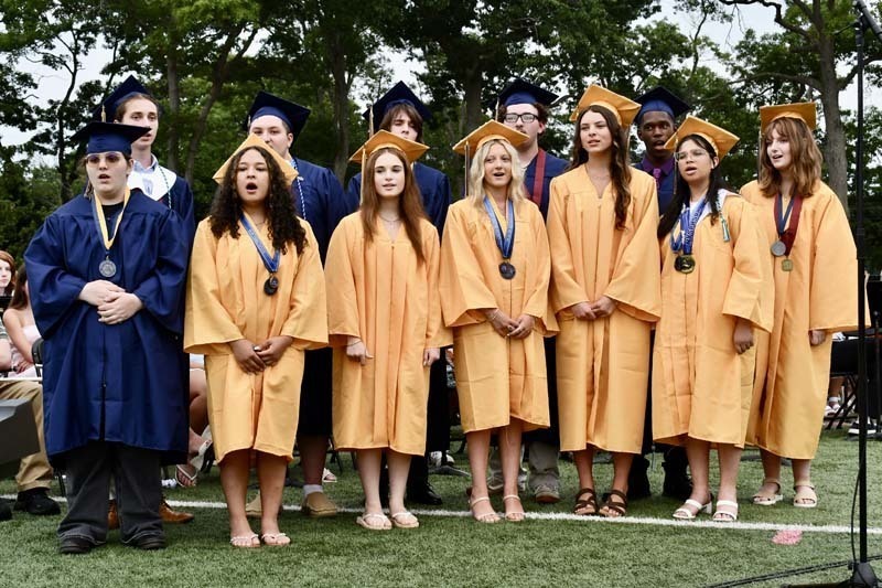 Graduating students smiling.