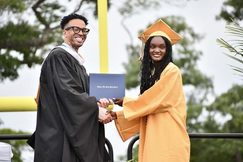 Graduating students smiling.
