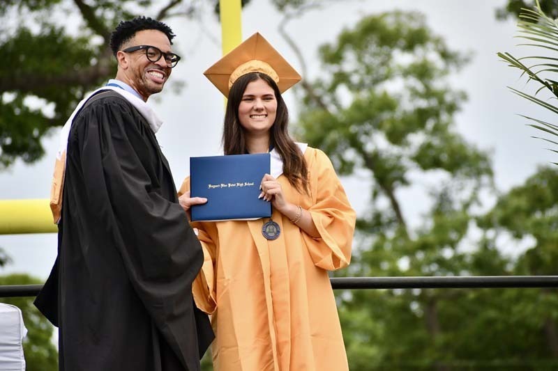 Graduating students smiling.