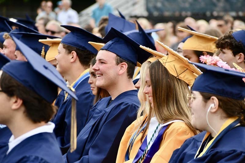 Graduating students smiling.