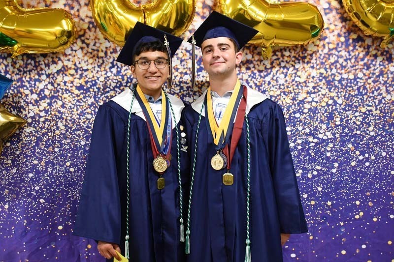 Graduating students smiling.