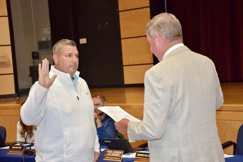 Board member being sworn in.