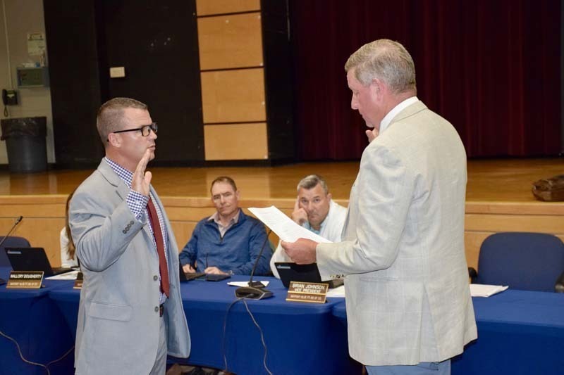 Board member being sworn in.